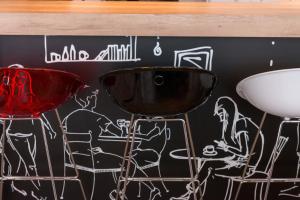 a wall with two bar stools and a drawing on it at Good Morning Gelsenkirchen City in Gelsenkirchen