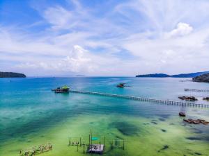 a large body of water with a dock in the water at Mad Monkey Koh Rong Samloem in Koh Rong Sanloem