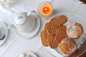 a table with a plate of cookies and a cup of tea at Hotel Gradara in Bellaria-Igea Marina