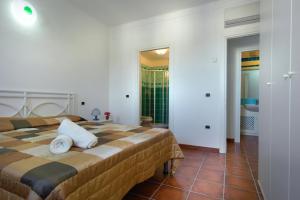 Cama o camas de una habitación en Perla Del Porto Apartments
