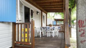 a porch of a house with a table and chairs at Camping Village Adriatico Giulianova in Giulianova