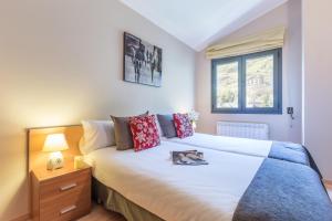ein Schlafzimmer mit großem Bett und Fenster in der Unterkunft Pierre & Vacances Andorra El Tarter in El Tarter