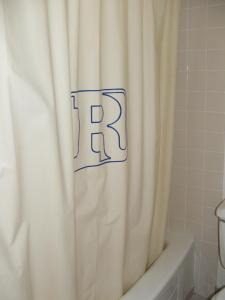 a bathroom with a shower curtain with the rtk on it at Arizona Inn in Kingman