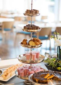 a three tiered tray of food on a table at Hotel Öresund Conference & Spa in Landskrona