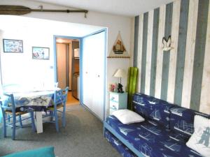 a bedroom with a bed and a table and a room at KERRIAN in Arzon