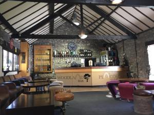 a bar with couches and tables in a room at Pencoed House Estate (Cardiff) in Cardiff