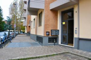 a sidewalk next to a building with a parking lot at CityWalls Guest House Bergamo in Bergamo