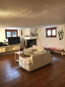 ein Wohnzimmer mit einem Sofa und einem Tisch in der Unterkunft Taverna tranquillissima indipendente in Trezzano sul Naviglio