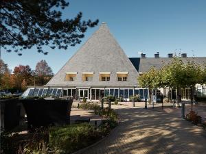 a large building with a pyramid shaped roof at Carlton President in Utrecht