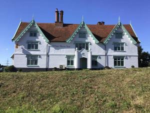 a large white house on top of a hill at Oak Cottage in Thorndon
