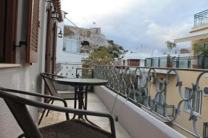 a balcony with a table and chairs on a building at Acropolis Apartment in Athens