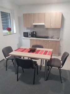 a kitchen with a table and chairs and a table and a table and chairsktop at Apartmaji Janković in Logatec +20 photos