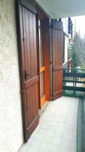 an entrance to a building with two wooden doors at Monterosa Apartment - Champoluc #Bluchalet in Champoluc