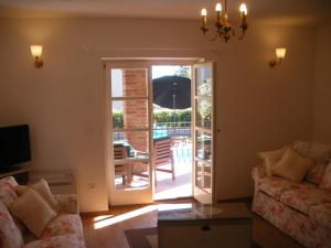 a living room with a door open to a patio at Villa Petra in Poreč