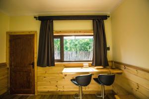 a room with a window with two chairs in front of it at Kalfu Patagonia in Cochrane