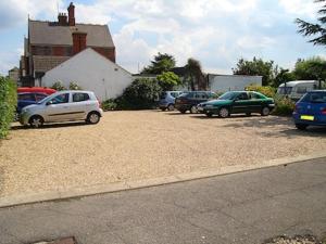 a group of cars parked in a parking lot at White Heather Guest House in Mablethorpe