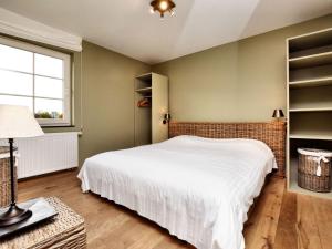 ein Schlafzimmer mit einem weißen Bett und einem Fenster in der Unterkunft Modern Villa in Durbuy with Swimming Pool in Villers-Sainte-Gertrude