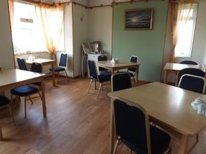 a room with tables and chairs in a room at White Heather Guest House in Mablethorpe