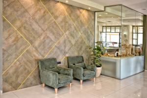 A seating area at Gouves Bay by Omilos Hotels