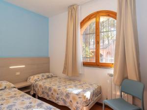 a room with two beds and a window at Bungalow in Po Delta Park with Beach Access in Lido di Spina +32 photos
