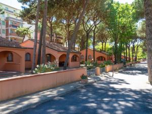a street in a city with trees and buildings at Bungalow in Po Delta Park with Beach Access in Lido di Spina
