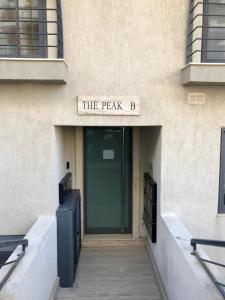 a building with a sign that reads the peak b at Merhba Apartment in St Paul's Bay