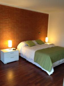 a bedroom with a large bed and two lamps at Barceló Suites Providencia I in Santiago