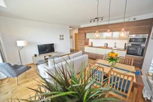 a kitchen and living room with a dining room at Grand Apartments - Three bedrooms with panorama of the Old Town in Gdańsk