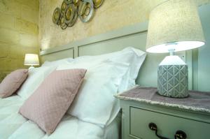 Ένα ή περισσότερα κρεβάτια σε δωμάτιο στο Santa Lucia B & B Suite