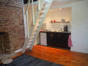 a stairway in a kitchen with a brick wall at L'Etage in Rennes