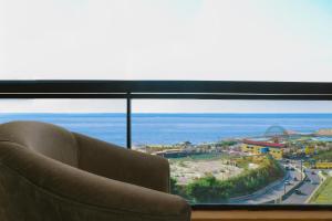 ベイルートにあるGrand Suites Hotelの大きな窓の前に座るソファ