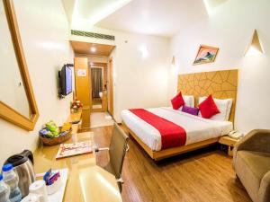 a hotel room with a bed and a tub at Hotel Rockdale in Visakhapatnam