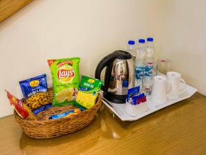 a counter with two baskets of breakfast food and drinks at Hotel Rockdale in Visakhapatnam