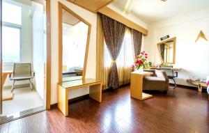 a living room with a couch and a chair at Hotel Rockdale in Visakhapatnam