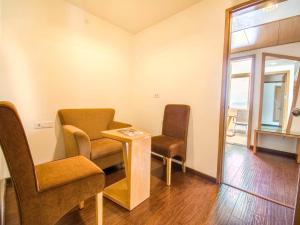 a waiting room with two chairs and a table at Hotel Rockdale in Visakhapatnam