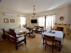 a living room with a couch and a table at Mezapos Villa Makrina in Mézapos