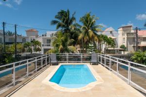 a swimming pool on the balcony of a building at Fantasea Villa - Mont Choisy in Mont Choisy