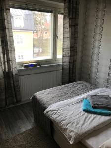 ein Schlafzimmer mit einem Bett und einem Fenster in der Unterkunft Residence 4 in Tampere