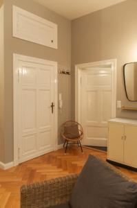 a living room with a white door and a chair at Studio Apartment Berlin in Berlin