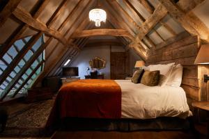 a bedroom with a large bed in an attic at The Bell in Ticehurst in Ticehurst