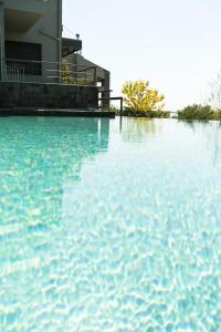 a large pool of water in front of a house at Olivia Estate Villa with Private Swimming Pool in Elia
