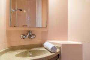 a bathroom with a sink with a towel on it at Premiere Classe Saintes in Saintes