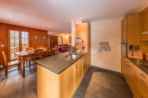 a kitchen with a counter and a dining room at Chalet Le Troll - Nendaz in Nendaz