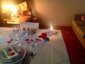 a table with a candle and a plate of food at AGRITURISMO NUOVA FATTORIA in Borgo Sabotino