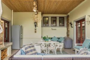 a living room with a table and chairs at Peace Valley Guesthouse in Napier