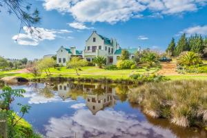 a large house with a pond in front of it at Peace Valley Guesthouse in Napier