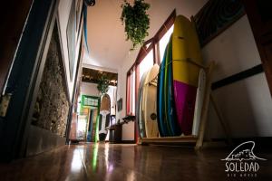 a group of surfboards are lined up against a wall at Atlantis Surf Hostel in Moya