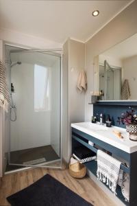 a bathroom with a sink and a shower at Camping Pascalounet in La Couronne