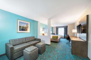 a hotel room with a couch and a bed at Comfort Inn & Suites Oklahoma City near Bricktown in Oklahoma City