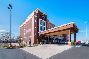 a large red brick building with a gas station at Comfort Inn & Suites Oklahoma City near Bricktown in Oklahoma City